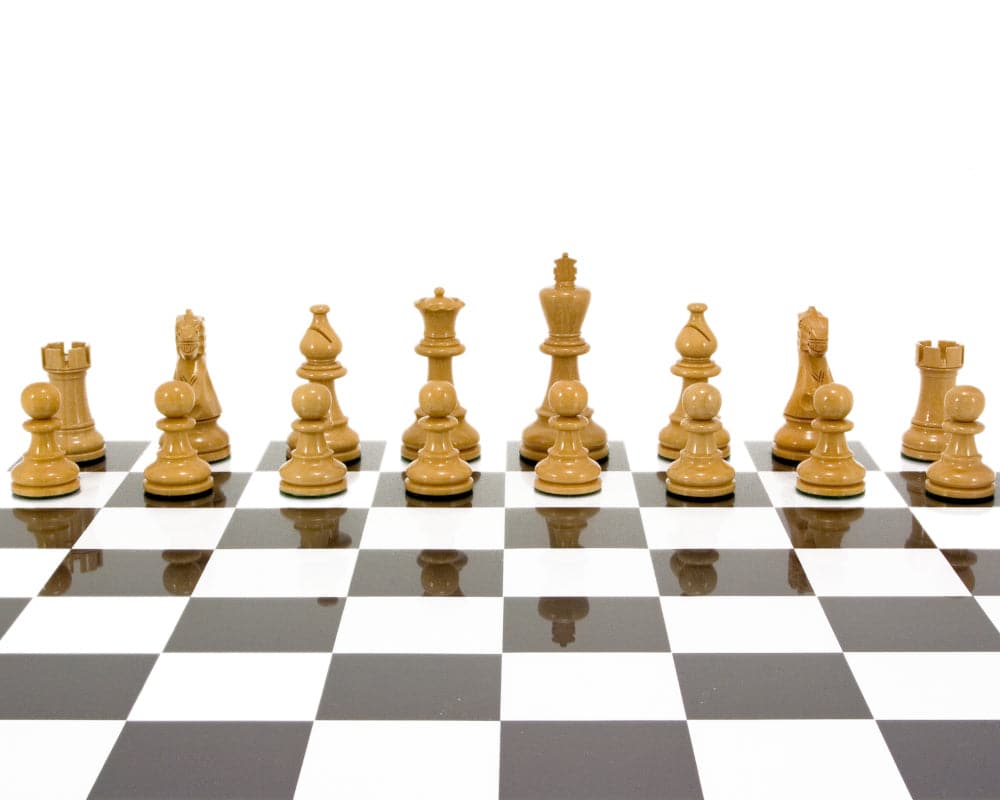 Atlantic Series Staunton black and natural lacquered chess pieces on a black and white chessboard, 3.75 inches high king