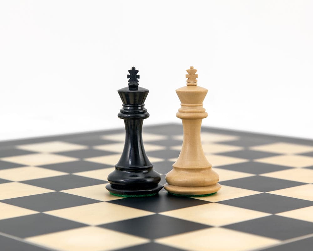 Highclere Series Ebony Staunton Chess Pieces with 3 inch king on chessboard