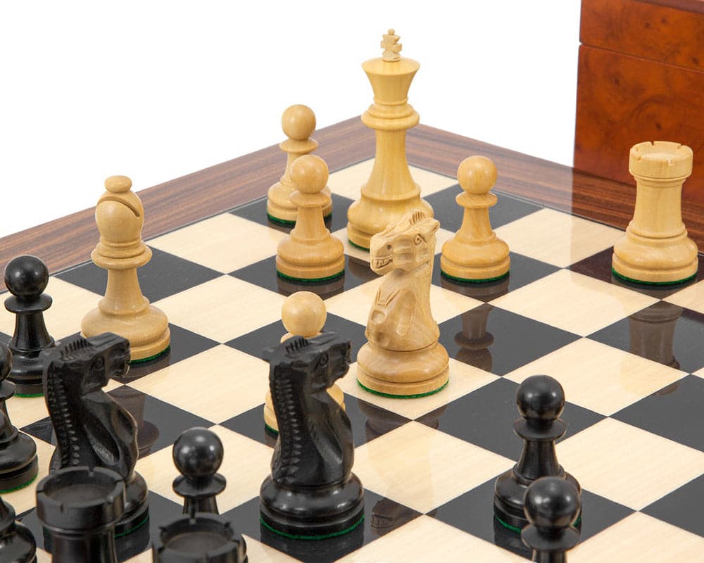 Supreme Ebony Chess Set with classic Staunton design on luxurious black and white board, featuring expertly crafted ebony and boxwood pieces.