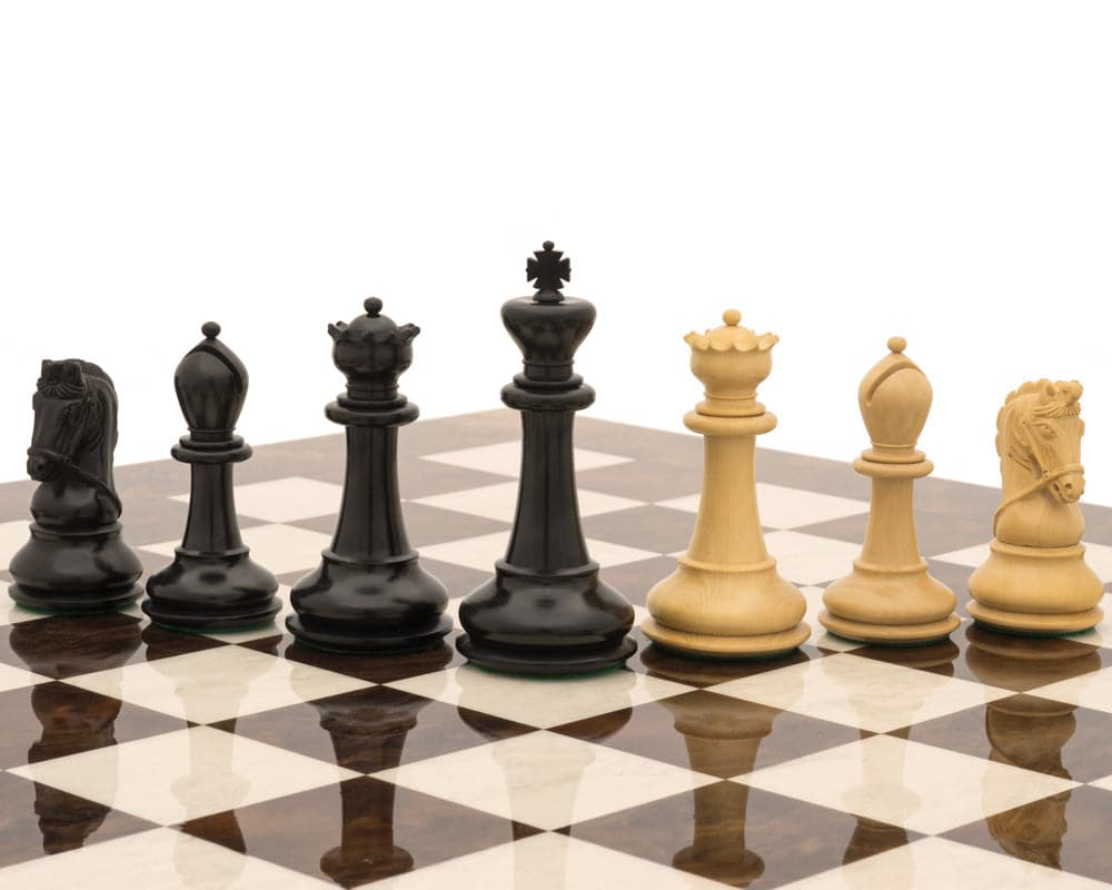 The Monarch Ebony And Walnut Grand Luxury Chess Set pieces on a chessboard