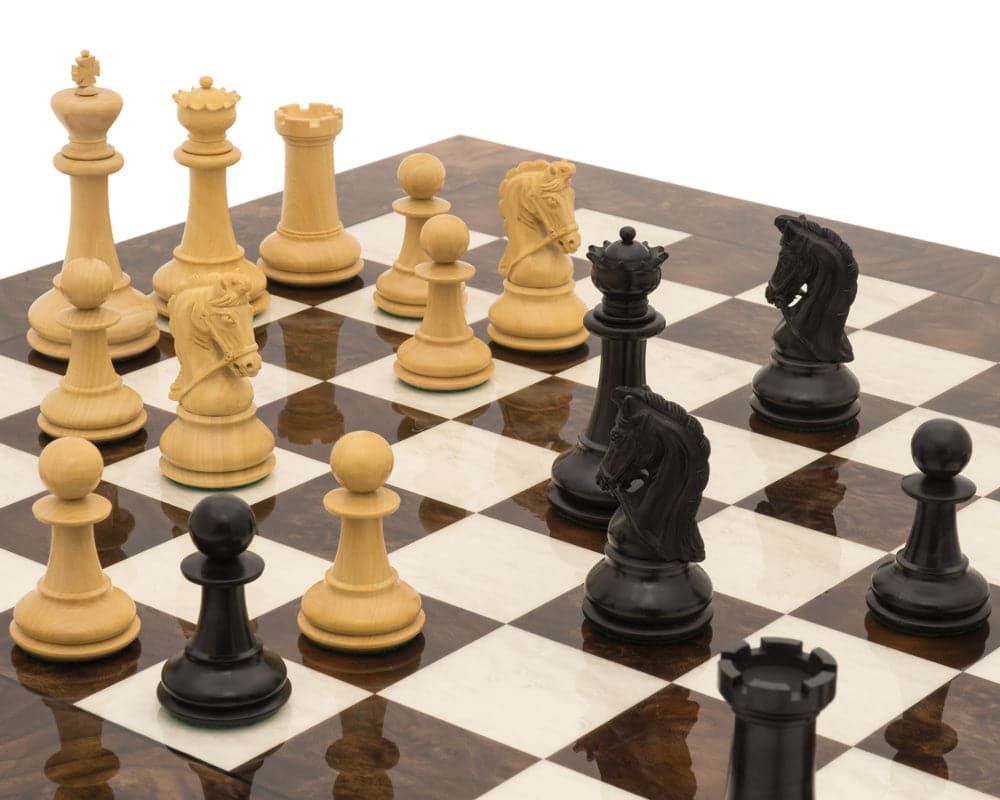 The Monarch Ebony and Walnut Grand Luxury Chess Set on a beautifully crafted chessboard, featuring detailed pieces in a game position.
