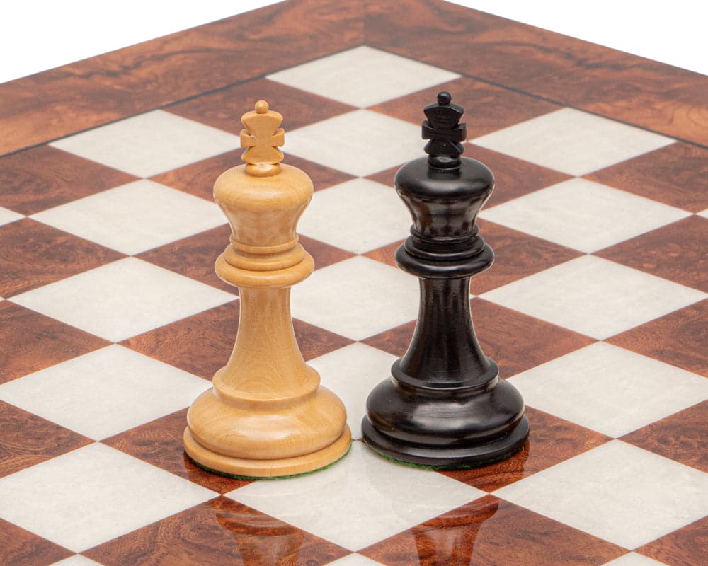Two Staunton chess kings from the Highgrove Briarwood and Black Luxury Chess Set on a 16.75 inch Italian briarwood and elm board.