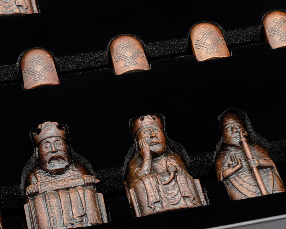 Detailed Isle of Lewis Chessmen in presentation case showcasing intricate craftsmanship and historical design.