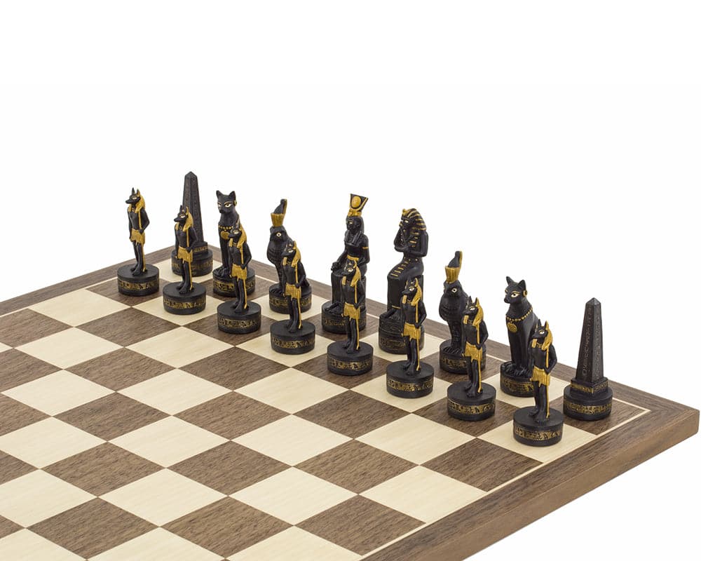 Ancient Egypt hand-painted chess pieces by Italfama on a chessboard, featuring ornately painted black and gold pieces.