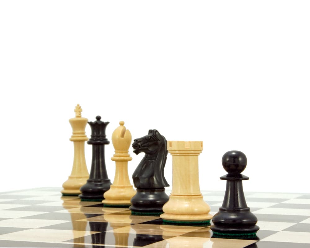 Ebonised boxwood and natural boxwood chess pieces from the Oxford Series on a chessboard