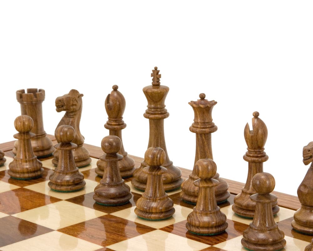 Hand turned Victoria Series Sheesham and Boxwood Chessmen on a chessboard, showcasing detailed wooden chess pieces with green flocked bases.