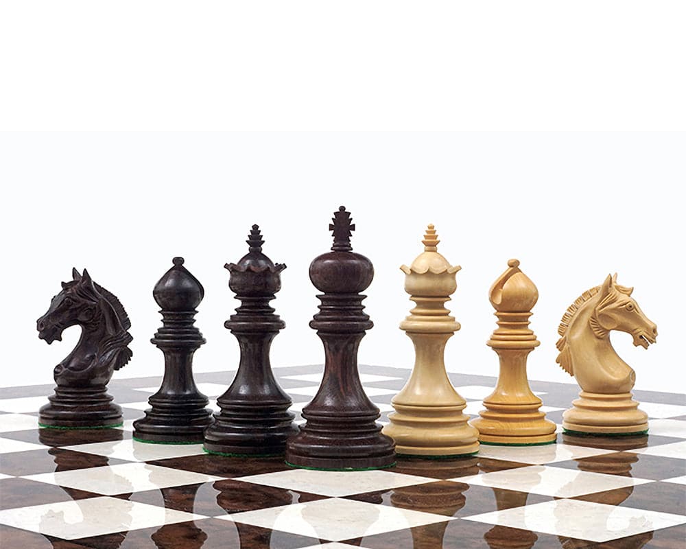 The Garvi 4 inch Rosewood Chessmen set on a 21 inch board, inspired by 16th century Indian history, featuring weighted pieces with billiard cloth bases.