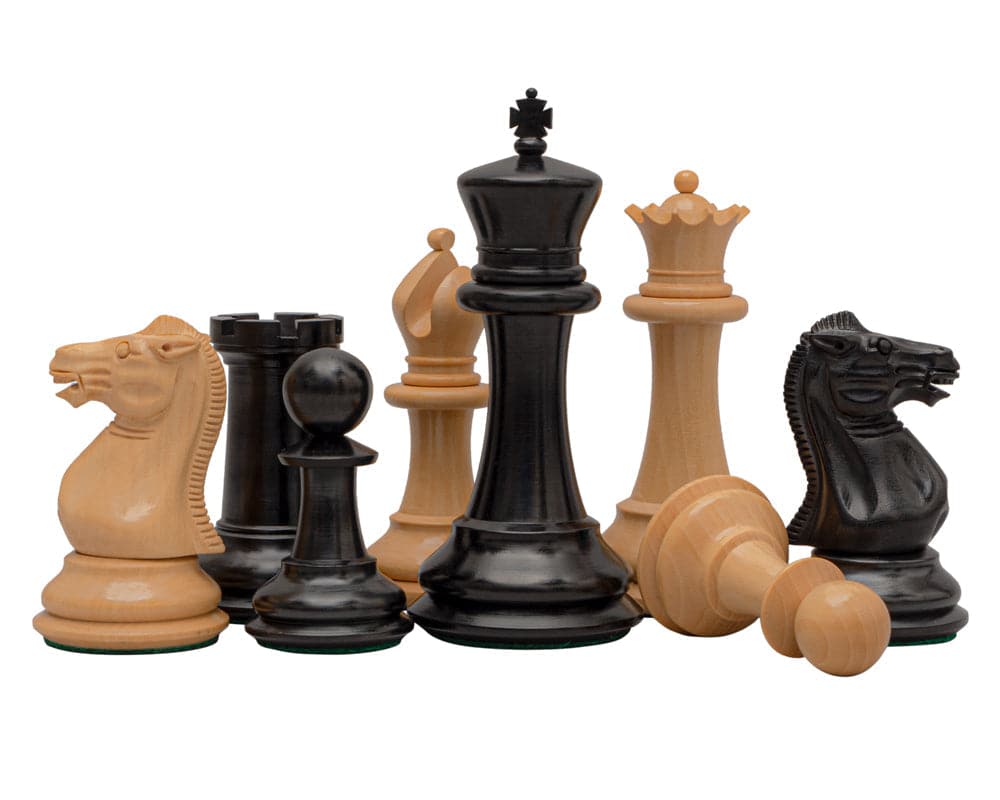 Reproduction Staunton Ebony Chessmen 1849 Model with 4.4 inch King, handcrafted in classic design from ebony and boxwood, set on display.