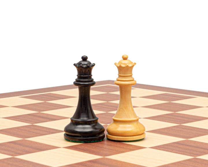 Ebonised and boxwood chess kings on chessboard in traditional Staunton design