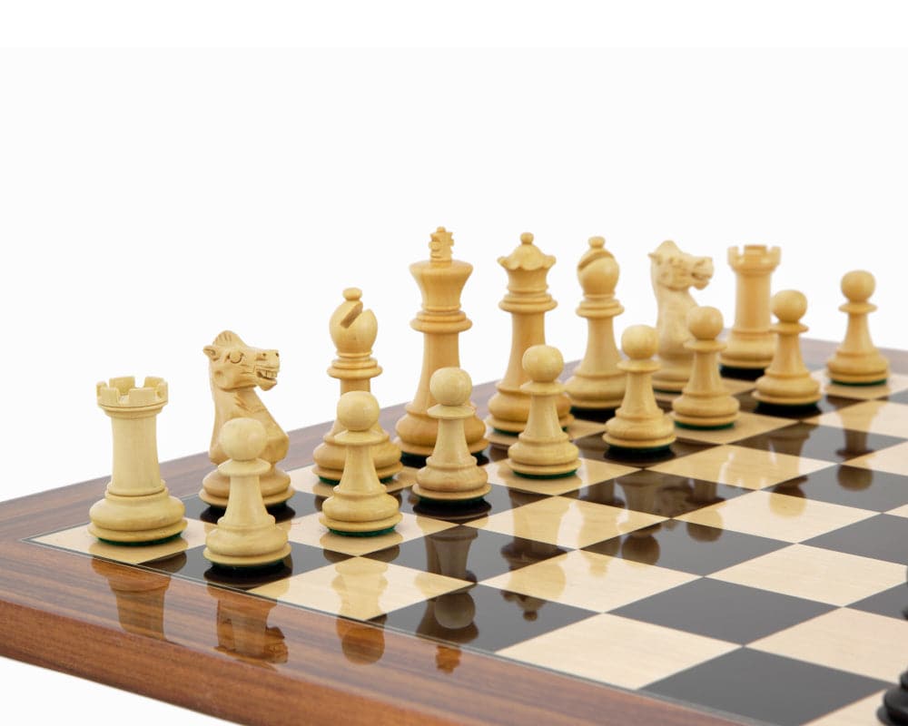 Traditional Staunton boxwood chess pieces on a wooden chessboard, featuring a 3-inch king and expertly turned, felted, and weighted chessmen.