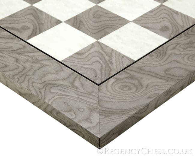 Close-up of grey ash burl chessboard corner from the Oxford Ash Burl Chess Set displaying grain pattern and gloss finish.