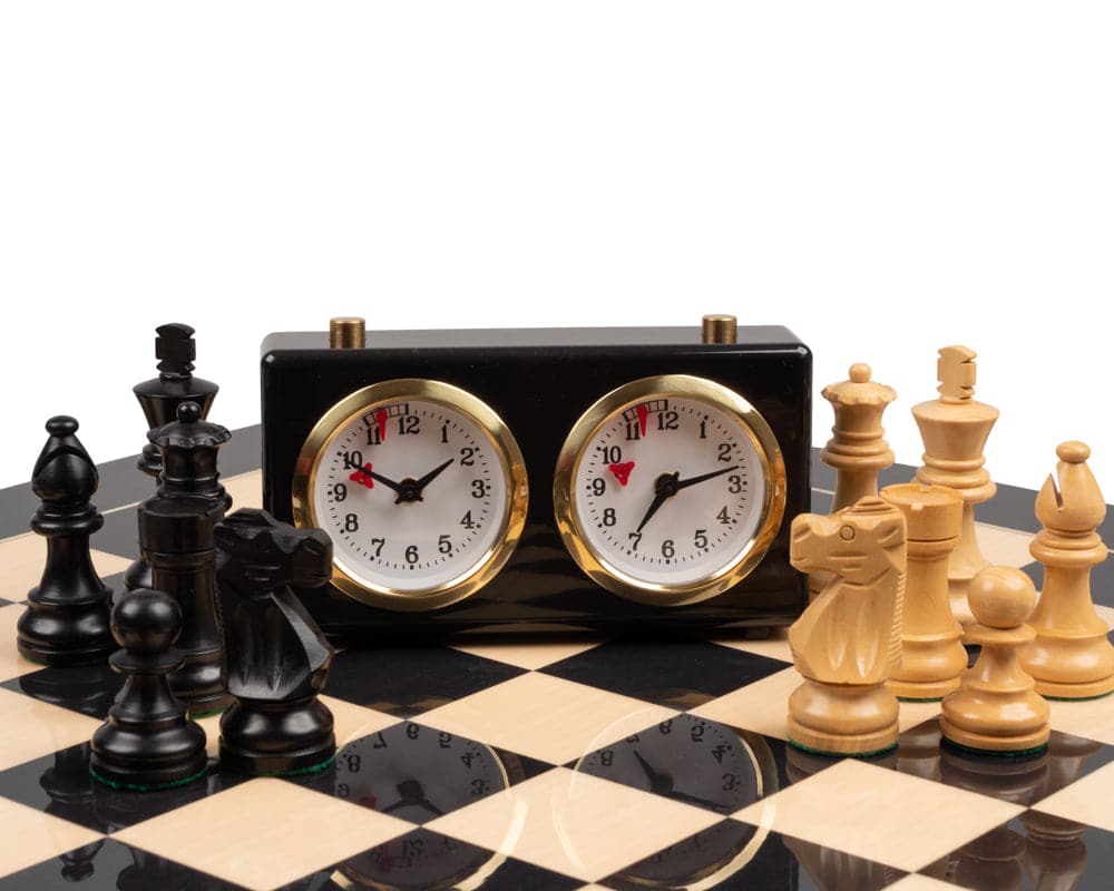 The French Knight Luxury Black Chess Set with Chess Clock on a black and white chessboard
