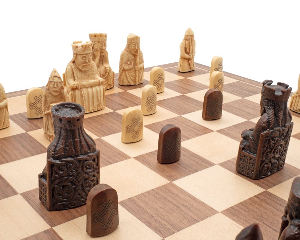 Isle of Lewis Chessmen and Board Presentation Set featuring intricately designed pieces by Italian craftsmen on a checkered chessboard.